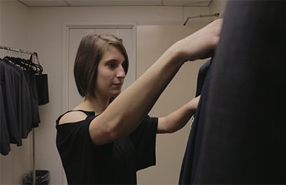 UH student Alexandra D'Amico looks at suits available for rental through Career Closet